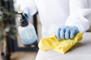 close up hand disinfecting couch